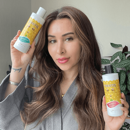 Thentix shampoo and hair conditioner being held by a person with light brown straight hair. She is smiling about how gentle Thentix shampoo and conditioner is your hair.